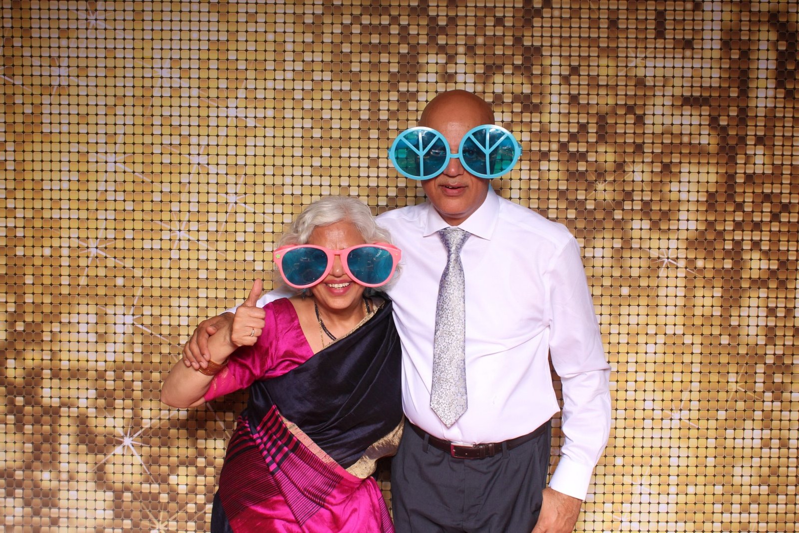 Senior wedding guests and grandparents giving a thumbs up wearing oversized novelty glasses